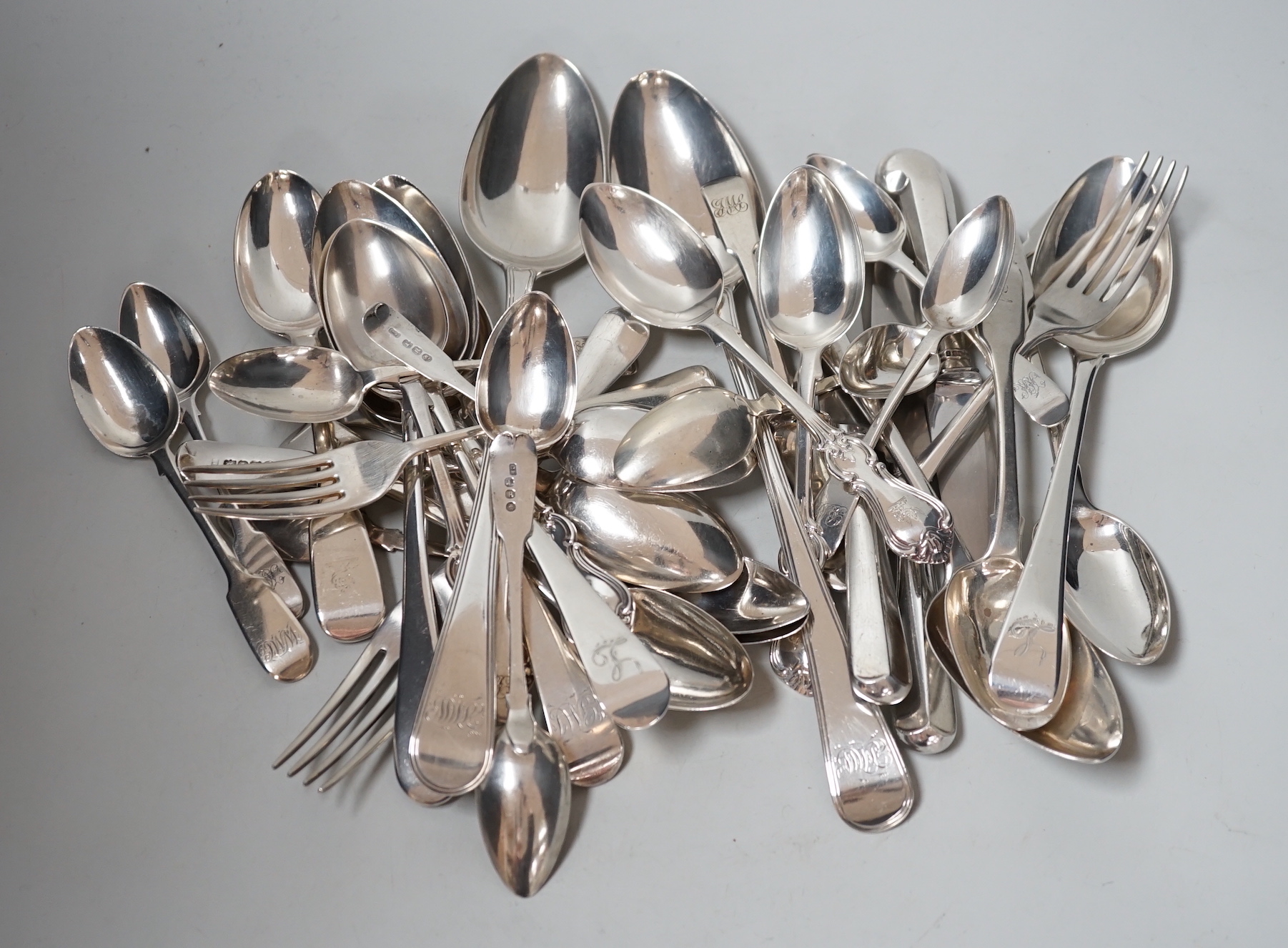 A canteen of mixed George III and later silver flatware, various patterns, dates and makers, 48.6oz.